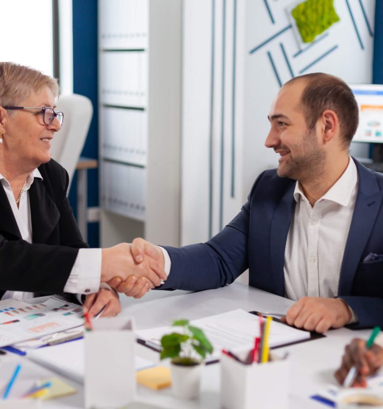 consultant-greeting-international-client-with-handshake-after-partnership.jpg